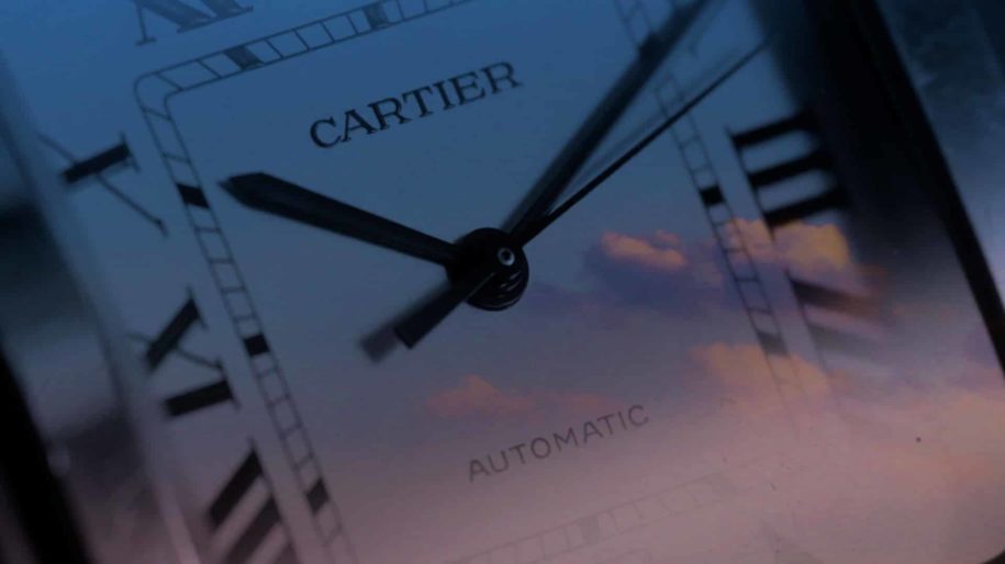 Cartier - The Iconic Age - Closeup mockup of clouds and Santos De Cartier Watch