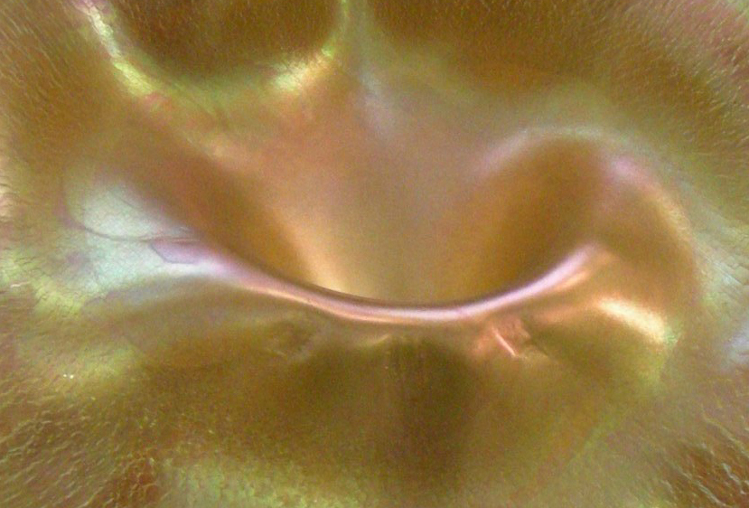 Golden opalescent glass detail by Louis Comfort Tiffany, glowing with an iridescent shimmer