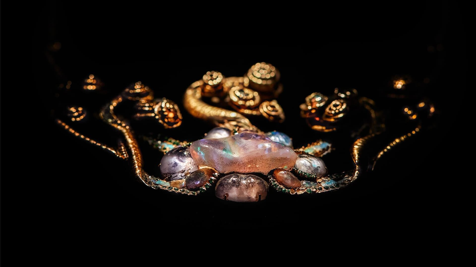 Exquisite Louis Comfort Tiffany Medusa pendant featuring iridescent opals and intricate gold filigree work.