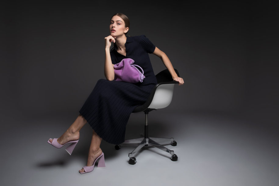 Neiman Marcus - Sweater Dress and Purple Velvet Bag Sitting on Herman Miller Chair