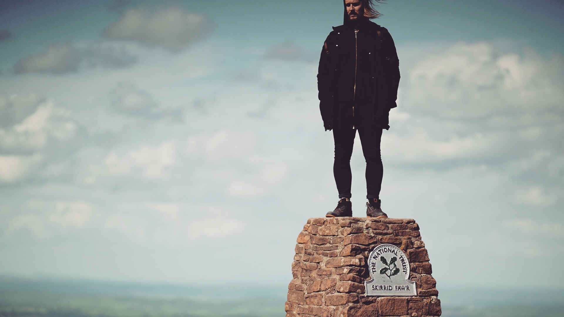 MUG5 standing on top of Skirrid Fawr, capturing the spirit of adventure and creativity