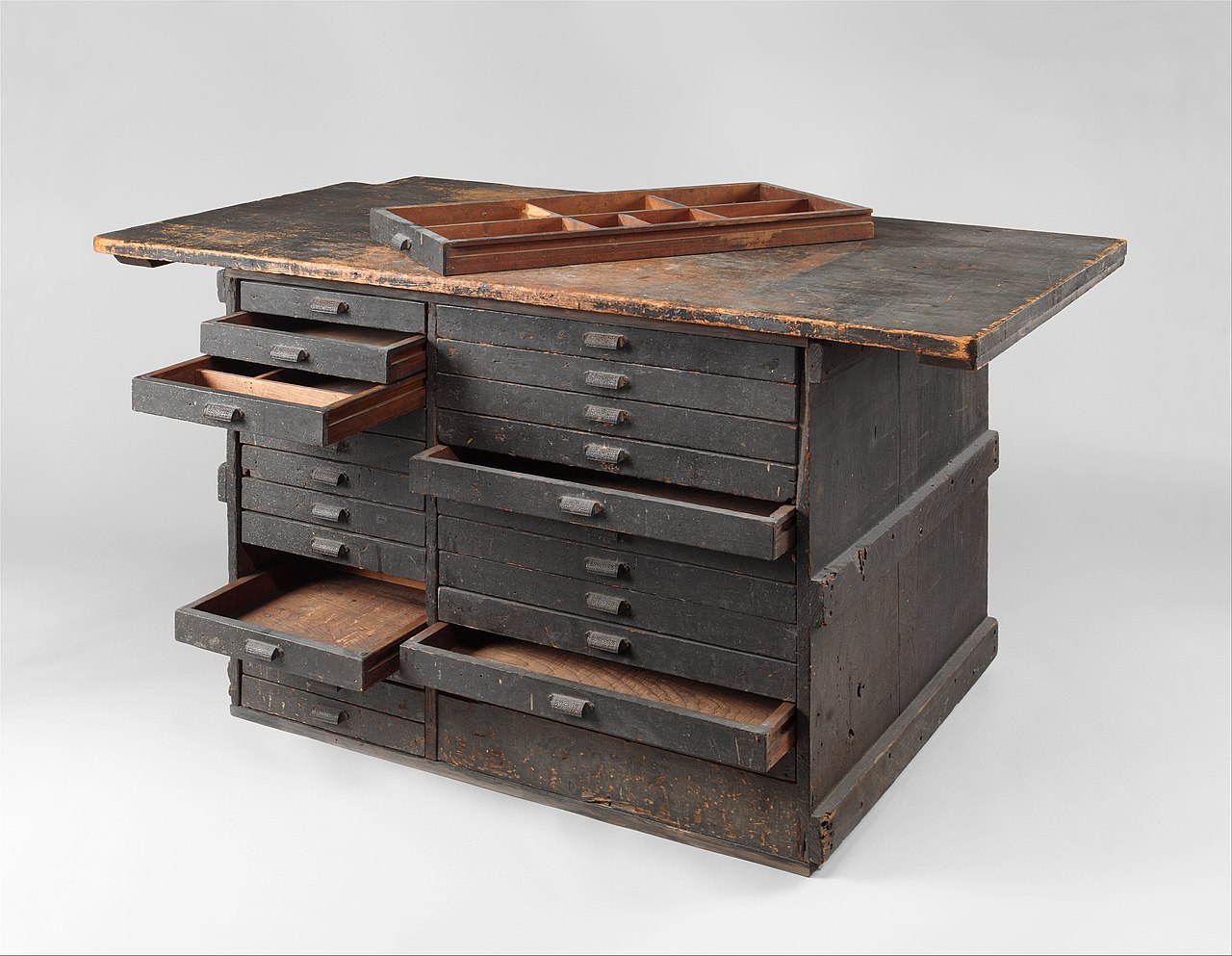 Wooden work bench from Tiffany Studios, featuring multiple drawers and compartments, from the Metropolitan Museum of Art. Image via Wikimedia Commons.