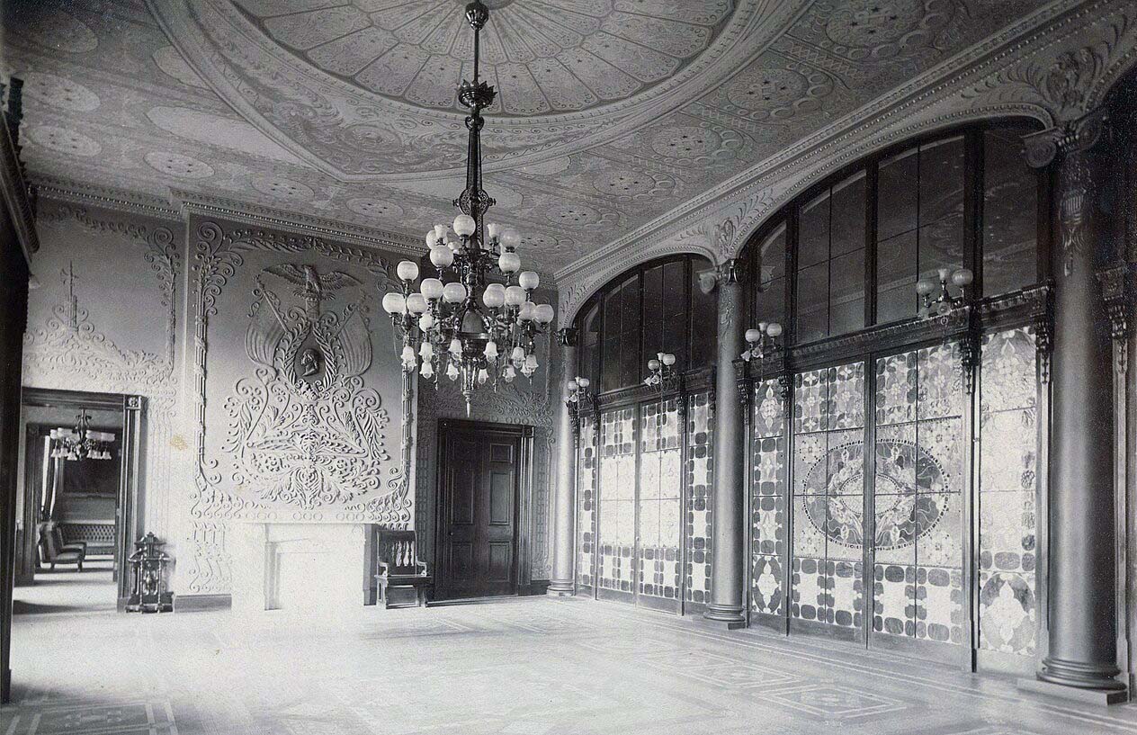 White House North Entrance Hall featuring Louis Comfort Tiffany’s stained glass screen, installed in 1882 under President Chester A. Arthur. Image via Wikimedia Commons.